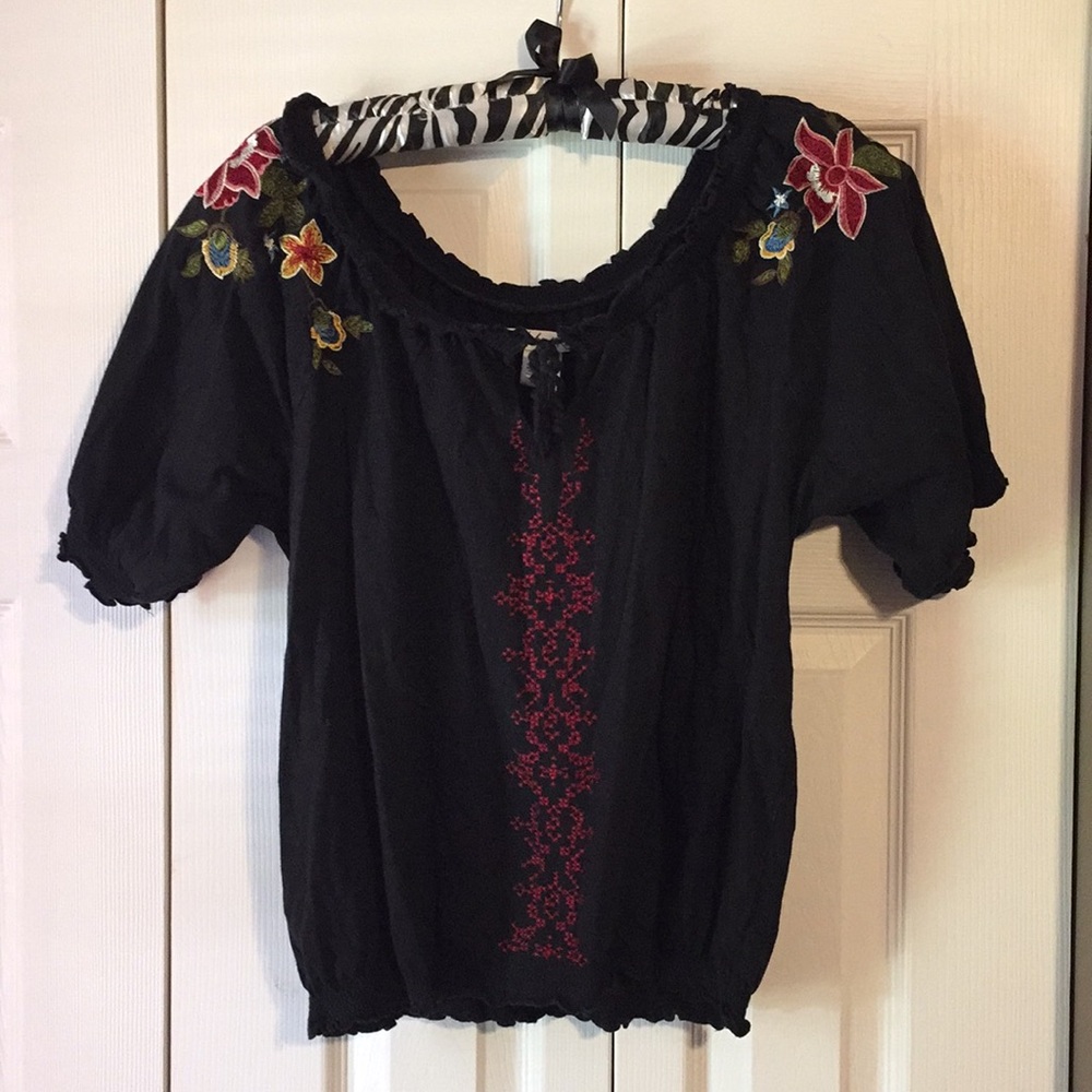 Black cotton blouse with floral embroidery.